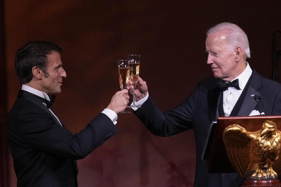 U.S. President Joe Biden and French President Emmanuel Macron toast their glasses after speaking at the state dinner on the South Lawn of the White House on December 1, 2022, in Washington, DC.  / Credit: Drew Angerer / Getty Images