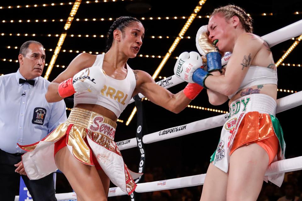 Amanda Serrano, left, punches Heather Hardy during the first round of a boxing match Friday, Sept. 13, 2019, in New York. Serrano won the fight. (AP Photo/Frank Franklin II)