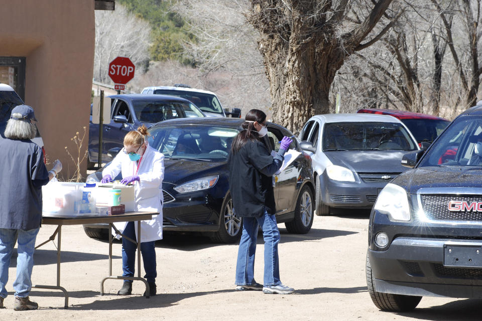 Cars line up for coronavirus testing at the Native American community of Picuris Pueblo, N.M., Thursday, April 23, 2020. Pueblo leaders including Gov. Craig Quanchello see COVID-19 as a potentially existential threat for the pueblo of just over 300 members and have implemented universal testing. (AP Photo/Morgan Lee)