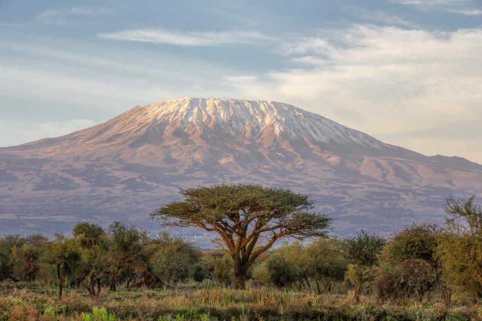 There are a few epic peaks around the world, like Everest, that you could spend a lifetime preparing to climb. Summiting Kilimanjaro, however, is a much more accessible adventure—local outfitters typically advise a three- to six-month training plan for getting in shape. In addition to the time needed to physically and mentally prepare, it'd be impossible to leave <a href="https://www.cntraveler.com/story/how-to-visit-tanzania-and-avoid-the-crowds?mbid=synd_yahoo_rss" rel="nofollow noopener" target="_blank" data-ylk="slk:Tanzania;elm:context_link;itc:0;sec:content-canvas" class="link ">Tanzania</a> without a safari in the sprawling Serengeti or a few days of letting your muscles loosen up on the beaches of <a href="https://www.cntraveler.com/gallery/stunning-photos-of-zanzibars-beaches-and-architecture?mbid=synd_yahoo_rss" rel="nofollow noopener" target="_blank" data-ylk="slk:Zanzibar.;elm:context_link;itc:0;sec:content-canvas" class="link ">Zanzibar.</a>