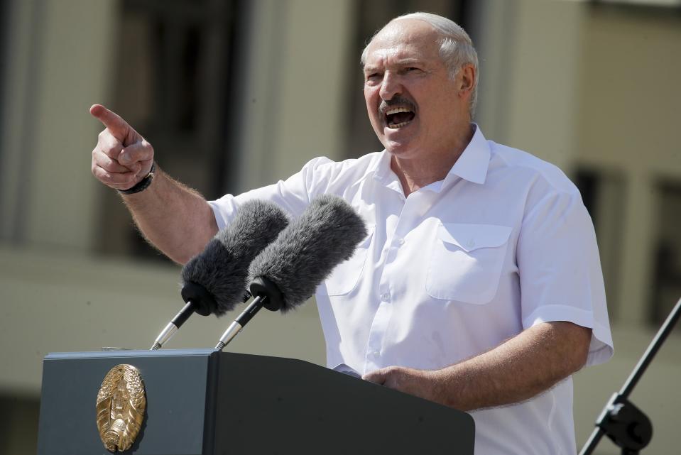 FILE - In this Sunday, Aug. 16, 2020 file photo Belarusian President Alexander Lukashenko addresses his supporters gathered at Independent Square of Minsk, Belarus. European Union leaders are putting on a show of support Wednesday Aug. 19, 2020 for people protesting in Belarus. Emergency talks will aim to highlight their concern about the contested presidential election and ratchet up pressure on officials linked to the security crackdown that followed. The EU believes that the results of the Aug. 9 polls, which handed President Alexander Lukashenko his sixth term with 80% of the vote, "have been falsified," and the 27-nation bloc is preparing a list of Belarus officials who could be blacklisted from Europe over their roles. (AP Photo/Dmitri Lovetsky, File)