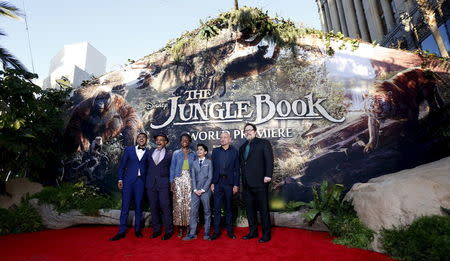Director of the movie Jon Favreau (R) poses with cast members (L-R) Ritesh Rajan, Giancarlo Esposito, Lupita Nyong'o, Neel Sethi and Ben Kingsley at the premiere of "The Jungle Book" at El Capitan theatre in Hollywood, California April 4, 2016. REUTERS/Mario Anzuoni