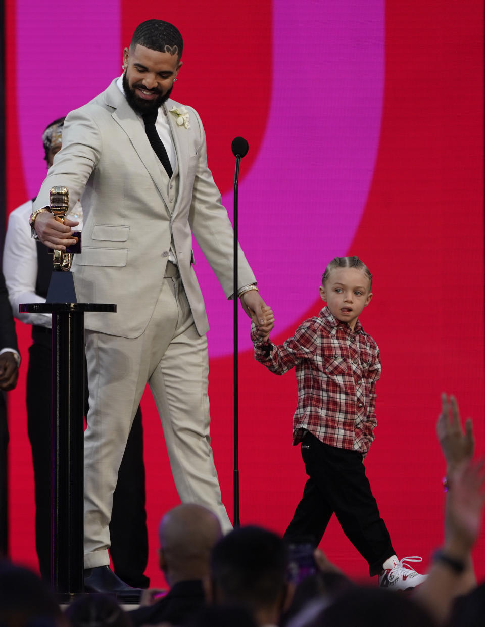 Drake accepts the artist of the decade award as he holds his son Adonis Graham at the Billboard Music Awards on Sunday, May 23, 2021, at the Microsoft Theater in Los Angeles. (AP Photo/Chris Pizzello)