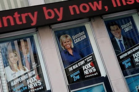 Posters of Fox News personalities including Gretchen Carlson, (C) who was recently fired from Fox News and who has filed a sexual harassment lawsuit against Fox News Chairman and CEO Roger Ailes, are seen at the News Corporation headquarters building in Manhattan, New York, U.S., July 6, 2016. REUTERS/Mike Segar