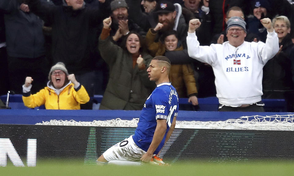 Everton's Richarlison celebrates scoring his side's first goal of the game, during the English Premier League soccer match between Everton and Chelsea at Goodison Park in Liverpool, England, Sunday March 17, 2019. (Martin Rickett/PA via AP)