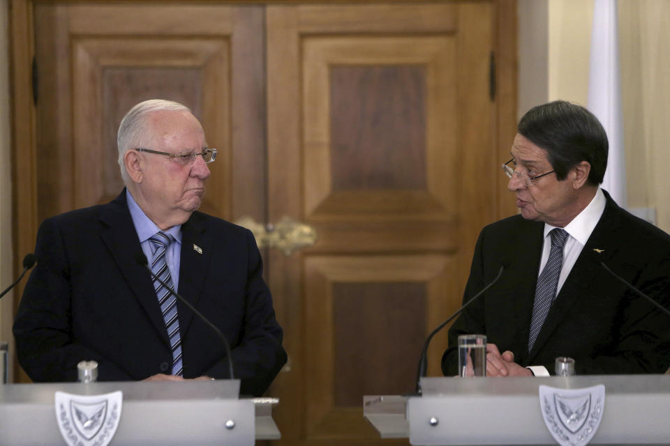 Cyprus' President Nicos Anastasiades, right, and Israel's President Reuven Rivlin talk to the media during a press conference after their meeting at the presidential palace in divided capital Nicosia, Cyprus, Tuesday, Feb. 12, 2019. Rivlin is in Cyprus for a one-day official visit for talks. (AP Photo/Petros Karadjias)