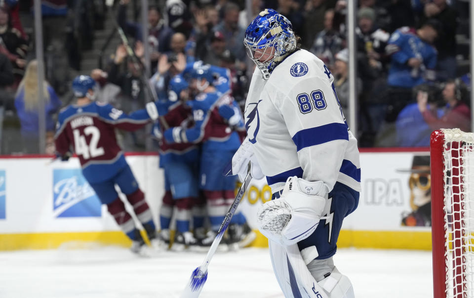 Tampa Bay Lightning goaltender Andrei Vasilevskiy, front, reacts after giving up a goal to Colorado Avalanche center Ryan Johansen in the first period of an NHL hockey game on Monday, Nov. 27, 2023, in Denver. (AP Photo/David Zalubowski)