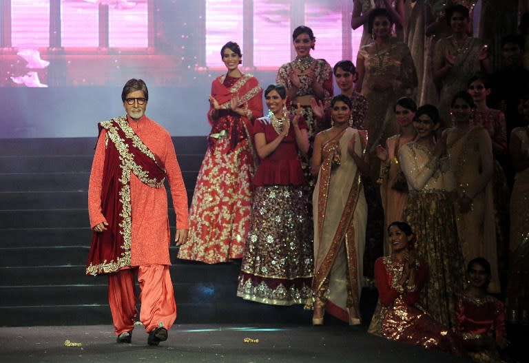 <p>Indian Bollywood actor Amitabh Bachchan walks as showstopper for designer Vikram Phadnis’s (3R) 25 years completion in the fashion industry in Mumbai on January 16, 2016. </p>