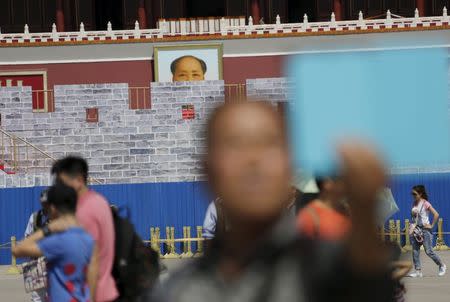 A portrait of China's late chairman Mao Zedong is seen behind the viewing stand for upcoming parade set up on Beijing's Tiananmen Square, August 27, 2015. REUTERS/Jason Lee