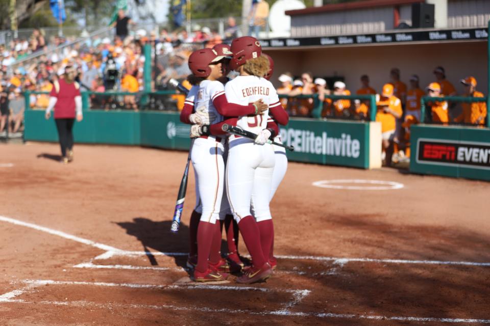 A group of FSU softball players huddle at home plate as the Seminoles take on No. 18 Tennessee in the St. Pete Clearwater Elite Invitational on Thursday, Feb. 17, 2022.