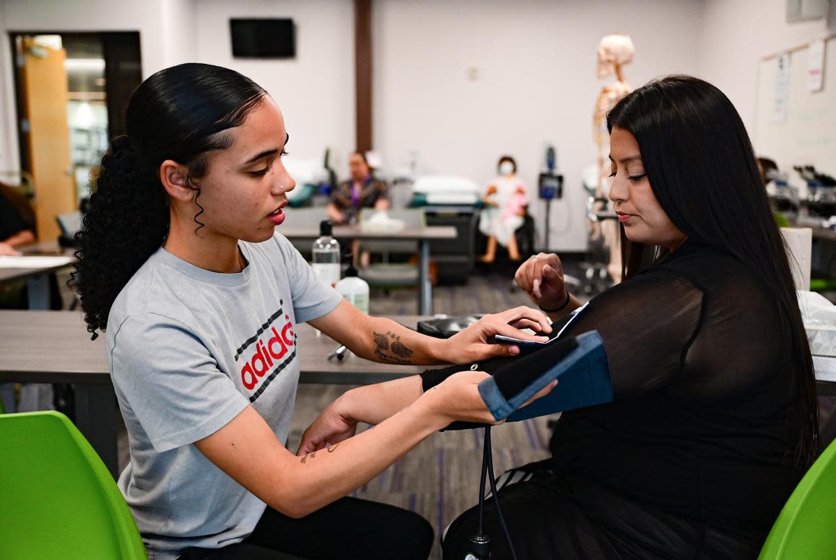 21-year-old Violet Fields measures Nora Hernandez-Mondragon’s blood pressure before class at the Leander Campus of Austin Community College on Oct. 4. The students were participating in a healthcare apprenticeship program for Baylor Scott & White employees.