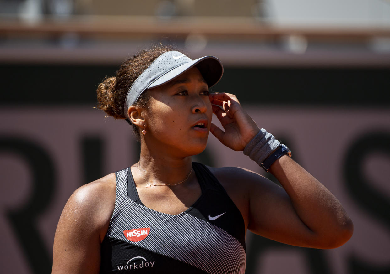 PARIS, FRANCE - MAY 30: Naomi Osaka of Japan looks to her team during her match against Patricia Maria Țig of Romania in the first round of the women’s singles at Roland Garros on May 30, 2021 in Paris, France.