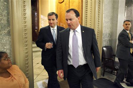 U.S. Senator Ted Cruz (R-TX) (back L) and Senator Mike Lee (R-UT) (front) depart the Senate floor after their speeches before the night-time budget vote at the U.S. Capitol in Washington, October 16, 2013. REUTERS/Jonathan Ernst