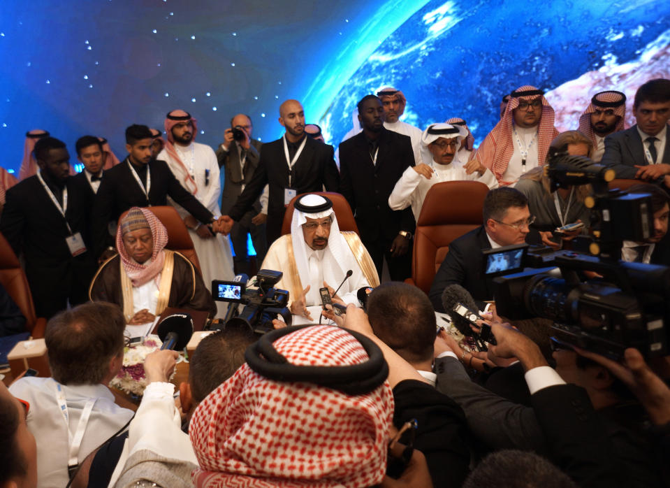 Russian Minister of Energy Alexander Novak, center right, Saudi Minister of Energy, Industry and Mineral Resources Khalid al-Falih, center, and OPEC Secretary General, Mohammed Sanusi Barkindo, center left, are surrounded by reporters during the opening of a meeting of energy ministers from OPEC and its allies to discuss prices and production cuts, in Jiddah, Saudi Arabia, Sunday, May 19, 2019. The meeting takes places as tensions flare in the Persian Gulf after the U.S. ordered bombers and an aircraft carrier to the region over an unexplained threat they perceive from Iran, which comes a year after the U.S. unilaterally pulled out of Tehran's nuclear deal with world powers and reimposed sanctions on Iranian oil. (AP Photo/Amr Nabil)