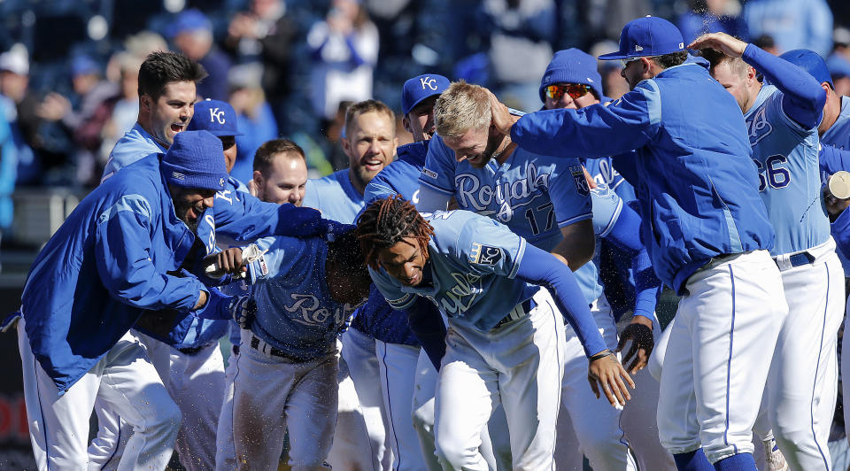 KANSAS CITY, MISSOURI - APRIL 14: Hunter Dozier #17 and Terrance Gore of the Kansas City Royals celebrate with teammates after Dozier hit the game winning single to score Gore from third in the ninth inning for a 9-8 win against the Cleveland Indians during the game at Kauffman Stadium on April 14, 2019 in Kansas City, Missouri. (Photo by John Sleezer/Getty Images)