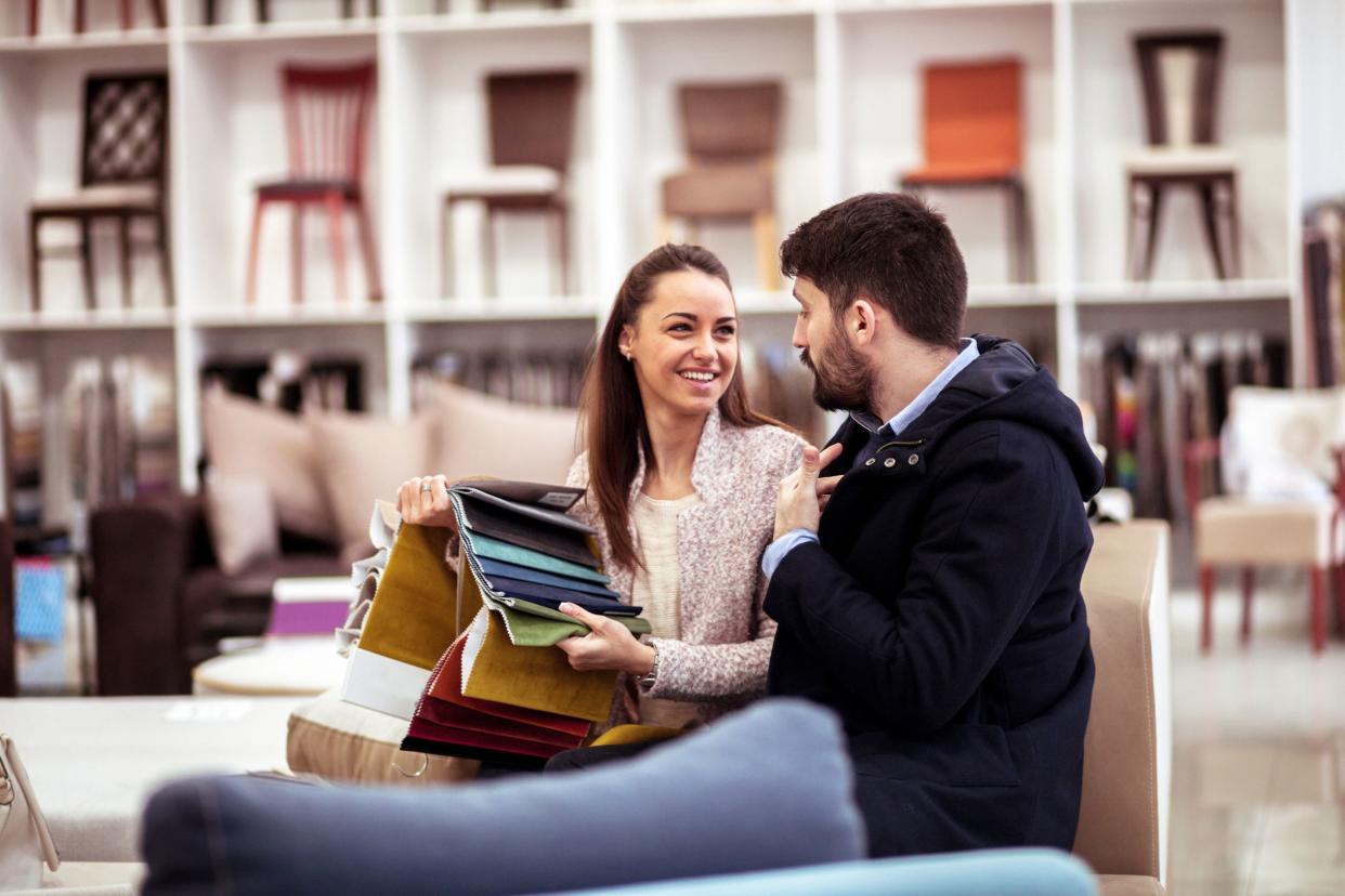 couple at a furniture store choosing fabrics