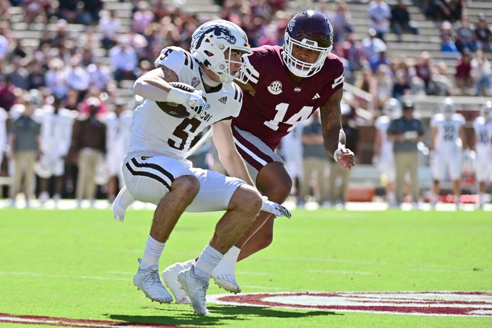 Western Michigan wide receiver Anthony Sambucci (5) runs the ball while defended by Mississippi State linebacker Nathaniel Watson (14) on Oct. 7, 2023, in Starkville, Miss.