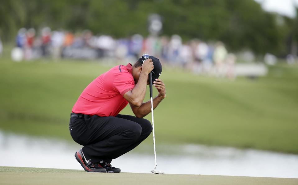 Tiger Woods bows his head on the fourth green during the final round of the Cadillac Championship golf tournament on Sunday, March 9, 2014, in Doral, Fla. Woods made bogey on the hole. (AP Photo/Lynne Sladky)