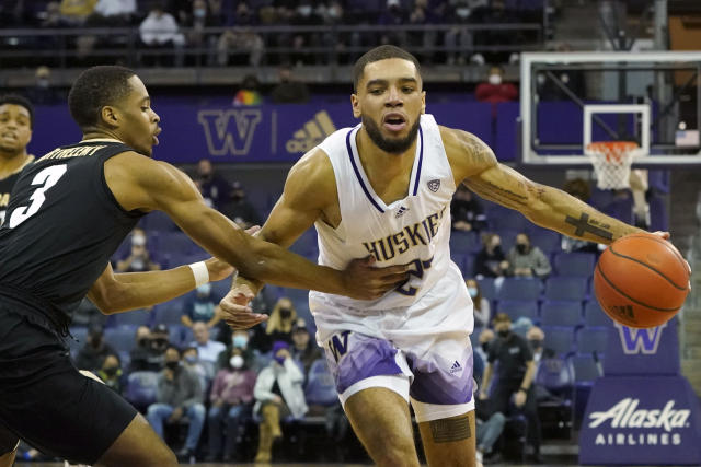 Washington guard Terrell Brown Jr., right, drives past Colorado guard Keeshawn Barthelemy, left, during the first half of an NCAA college basketball game, Thursday, Jan. 27, 2022, in Seattle. (AP Photo/Ted S. Warren)