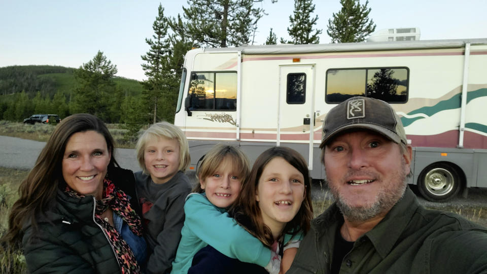 This Sept. 27, 2020 photo released by Breaux Walker, right, shows his family, from left, Edie Silver Walker, Stokes Walker, Mirakel Walker and Reyne Walker on the banks of the Madison River in Yellowstone National Park. n RVs, rental homes and five-star resorts, families untethered by the constraints of physical classrooms for their kids have turned the new school year into an extended summer vacation. (Breaux Walker via AP)