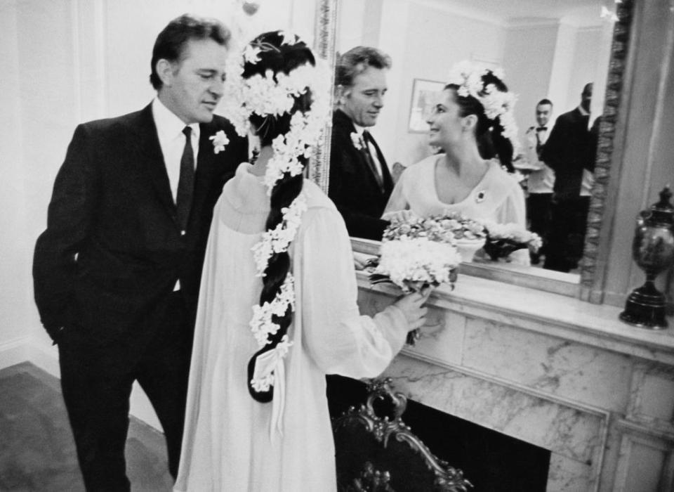 <p>Elizabeth Taylor and Richard Burton share an intimate moment at their first wedding in Montreal, Canada in 1964. They would eventually divorce, remarry, and divorce again.</p>