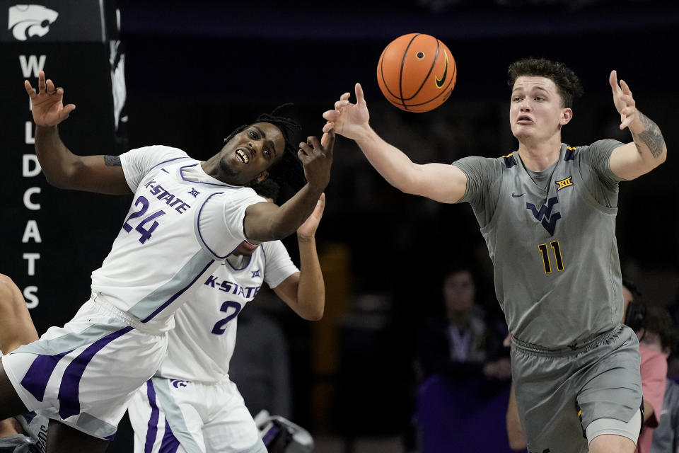 Kansas State forward Arthur Kaluma (24) and West Virginia forward Quinn Slazinski (11) chase after a loose ball during the second half of an NCAA college basketball game Monday, Feb. 26, 2024, in Manhattan, Kan. (AP Photo/Charlie Riedel)