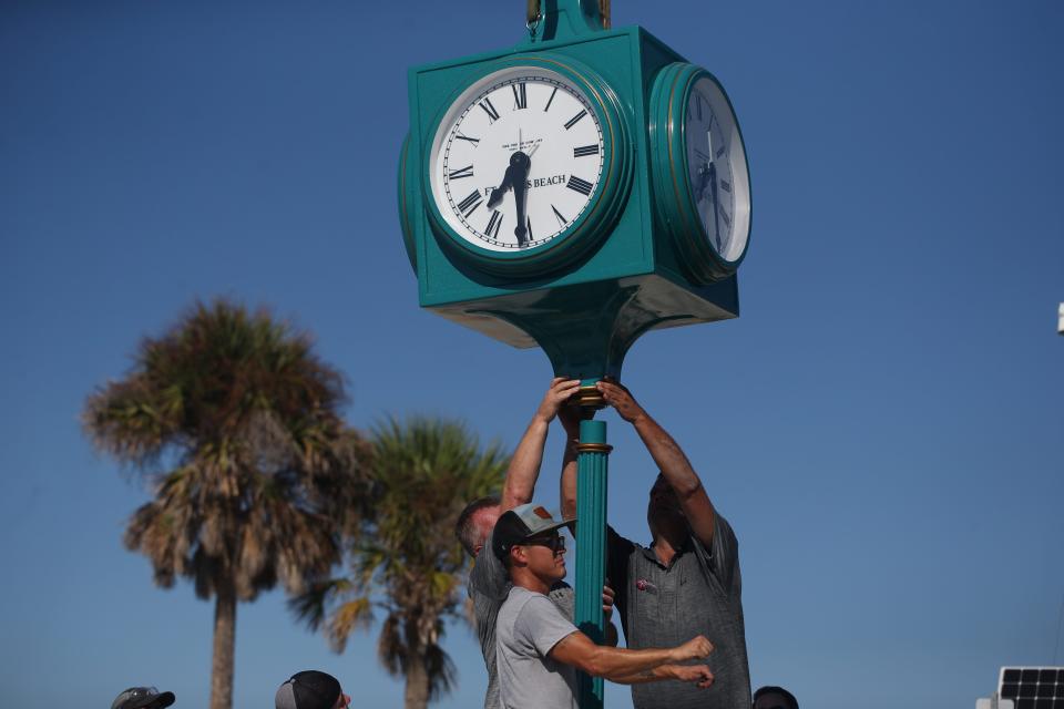 Crews with the Verdin Company and Kell]y General Contracting install the new clock in Times Square on Fort Myers Beach on Thursday, Sept. 14, 2023. The original clock was destroyed after Hurricane Ian decimated the island on Sept. 28, 2022 . The clock will be covered until it is unveiled during a ceremony on Sept. 28, 2023.