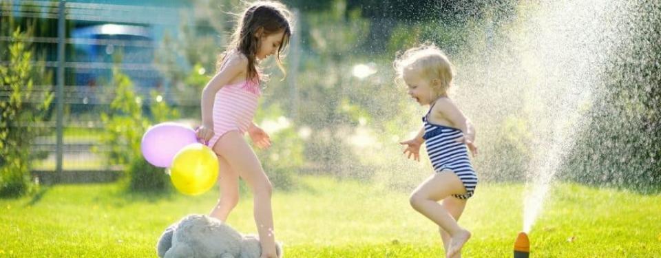 Kids playing with sprinkler