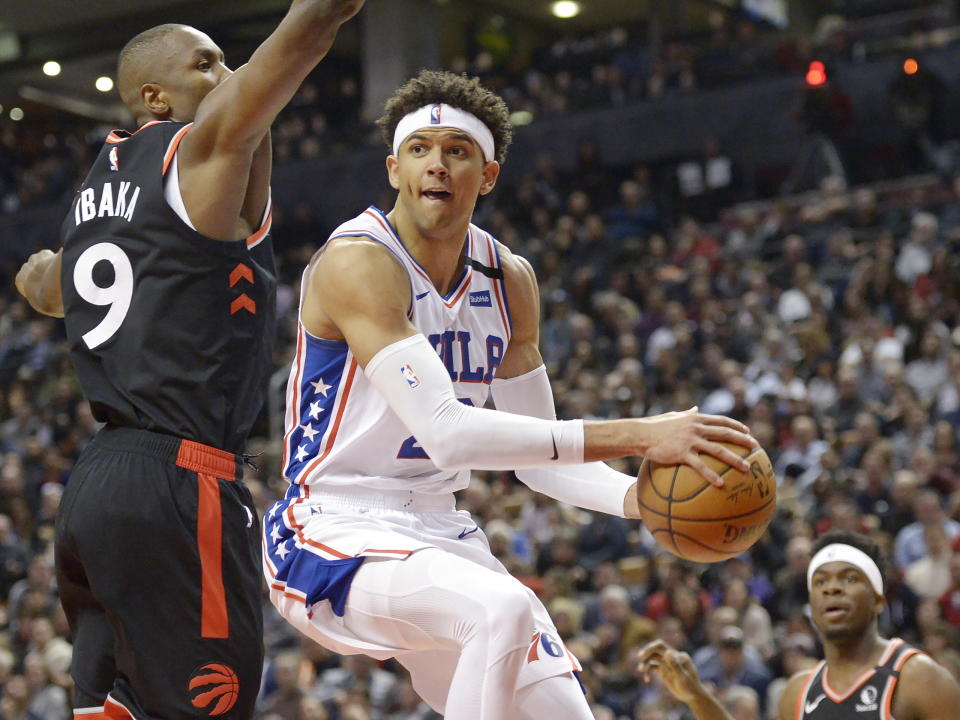 Philadelphia 76ers guard Matisse Thybulle (22) passes the ball around Toronto Raptors forward Serge Ibaka (9) during the second half of an NBA basketball game, Wednesday, Jan. 22, 2020 in Toronto. (Nathan Denette/The Canadian Press via AP)