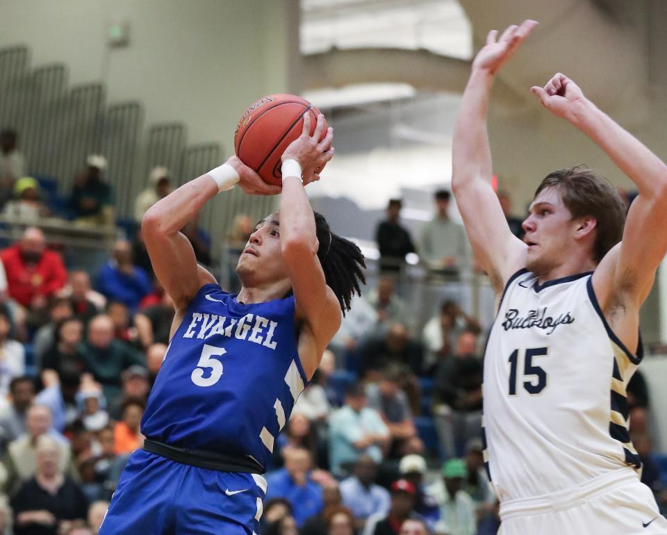 Evangel's Kyran Tilley shoots as Fairdale's Jacob Tucker defends during the Sixth Region championship at Valley High School.