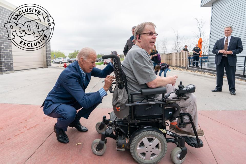 Biden signs the back of a supporter's wheelchair after speaking at Big Grove Brewery and Taproom in Des Moines, Iowa, on May 1, 2019.