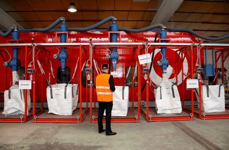 An employee works at Veolia’s solar panel recycling plant in Rousset, France, June 25, 2018. At the plant, photovoltaic panels are dissembled and their constituent parts such as glass, aluminium, silicon and plastics are recycled. REUTERS/Jean-Paul Pelissier