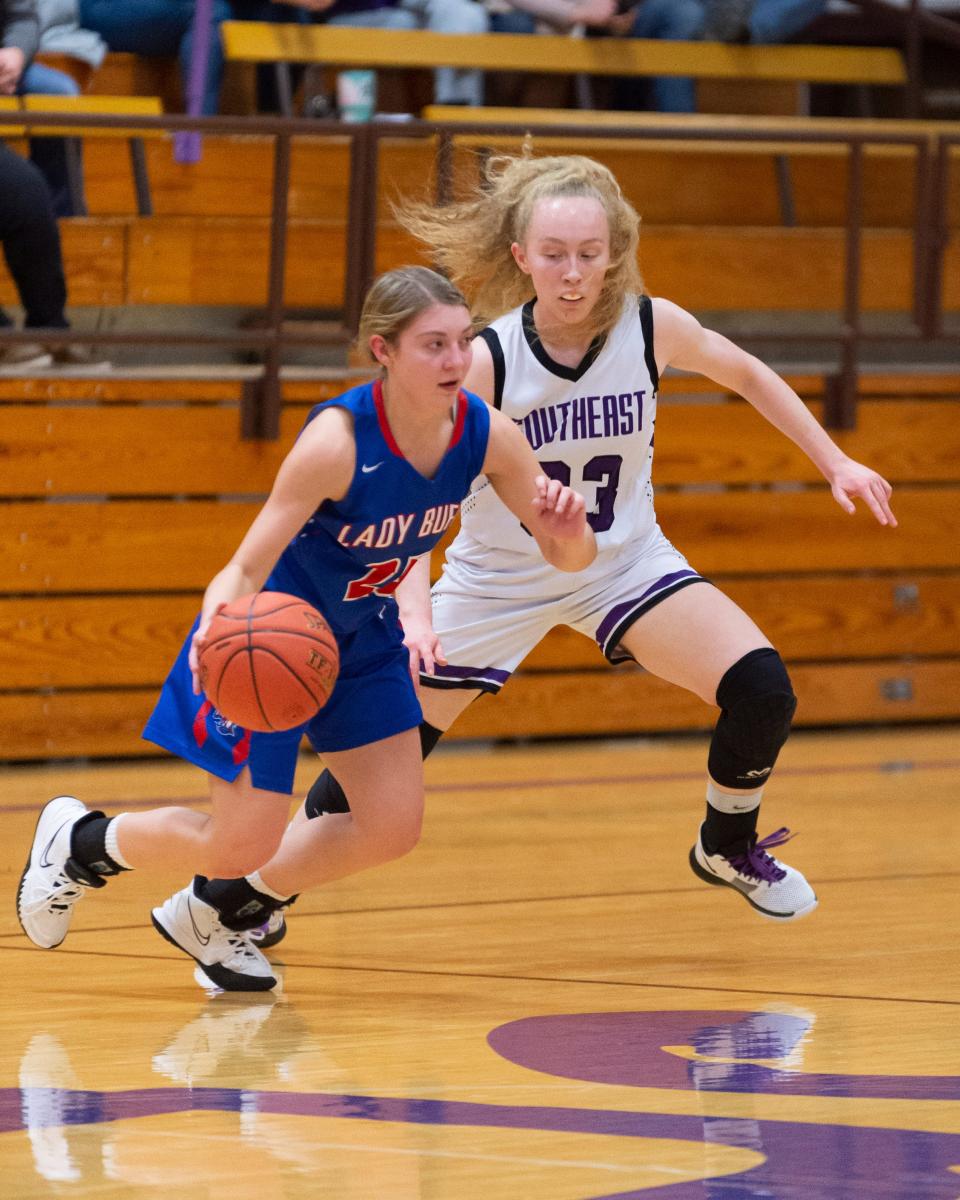 Southeast of Saline's Mallorie Pearson (33) defends against Republic County's Emily Hansen (25)  in Tuesday's 63-12 Trojan victory at SES.