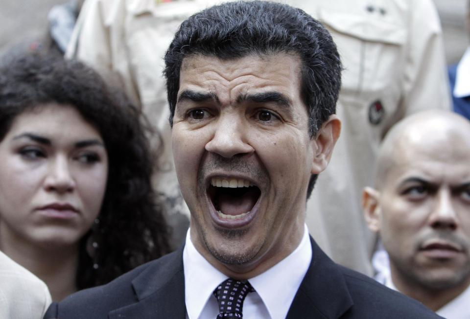 New York City Council member Ydanis Rodriguez, center, joins Occupy Wall Street protesters to denounce what they say is the NYPD's excessive use of force against demonstrators, in New York's Zuccotti Park, Monday, March 19, 2012. Police arrested 73 people on Saturday after hundreds of activists had gathered to mark the sixth-month birthday of the movement. (AP Photo/Richard Drew)