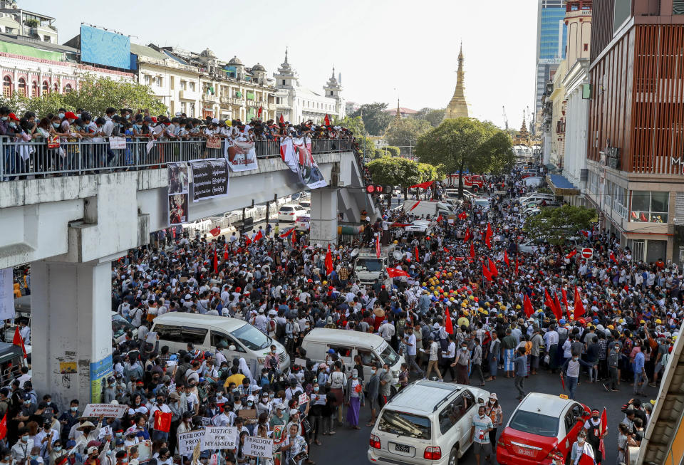 Demonstrator wave National League for Democracy party flags during a protest against the military coup in Yangon, Myanmar Wednesday, Feb. 10, 2021. Protesters continued to gather Wednesday morning in Yangon breaching Myanmar's new military rulers' decrees that effectively banned peaceful public protests in the country's two biggest cities. (AP Photo)