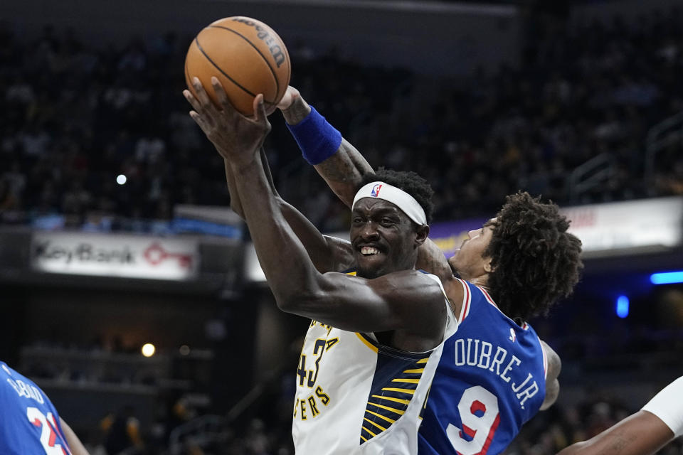 Indiana Pacers' Pascal Siakam (43) grabs a rebound against Philadelphia 76ers' Kelly Oubre Jr. (9) during the first half of an NBA basketball game Thursday, Jan. 25, 2024, in Indianapolis. (AP Photo/Darron Cummings)