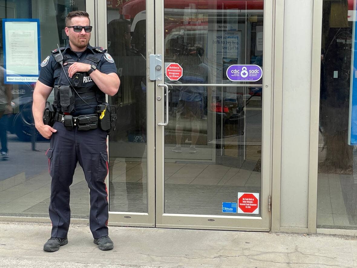 Police said a hold-up took place at approximately 12:57 p.m., at a bank in the Chinatown area, near Spadina Avenue and Dundas Street West. A man was rushed to hospital after being stabbed multiple times. (Michael Charles Cole/CBC - image credit)