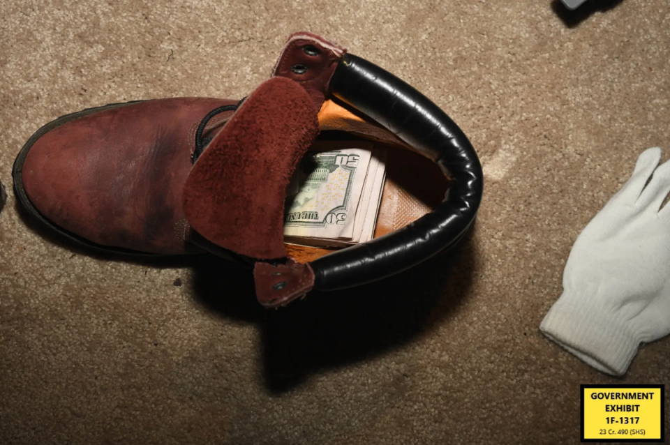 Cash was found in various places in the home, including a work Timberland brand work boot (FBI)