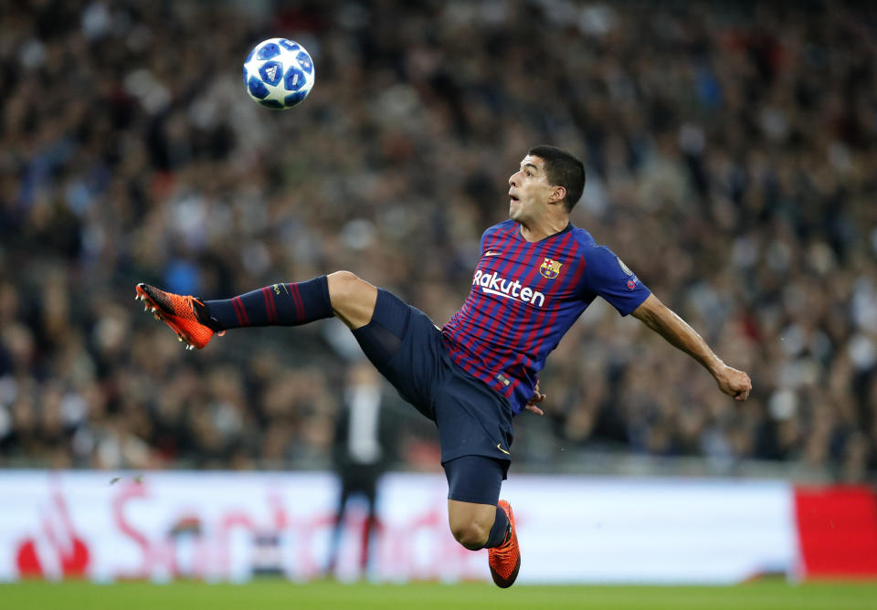 Barcelona forward Luis Suarez reaches for a ball during the Champions League Group B soccer match between Tottenham Hotspur and Barcelona at Wembley Stadium in London, Wednesday, Oct. 3, 2018. (AP Photo/Frank Augstein)