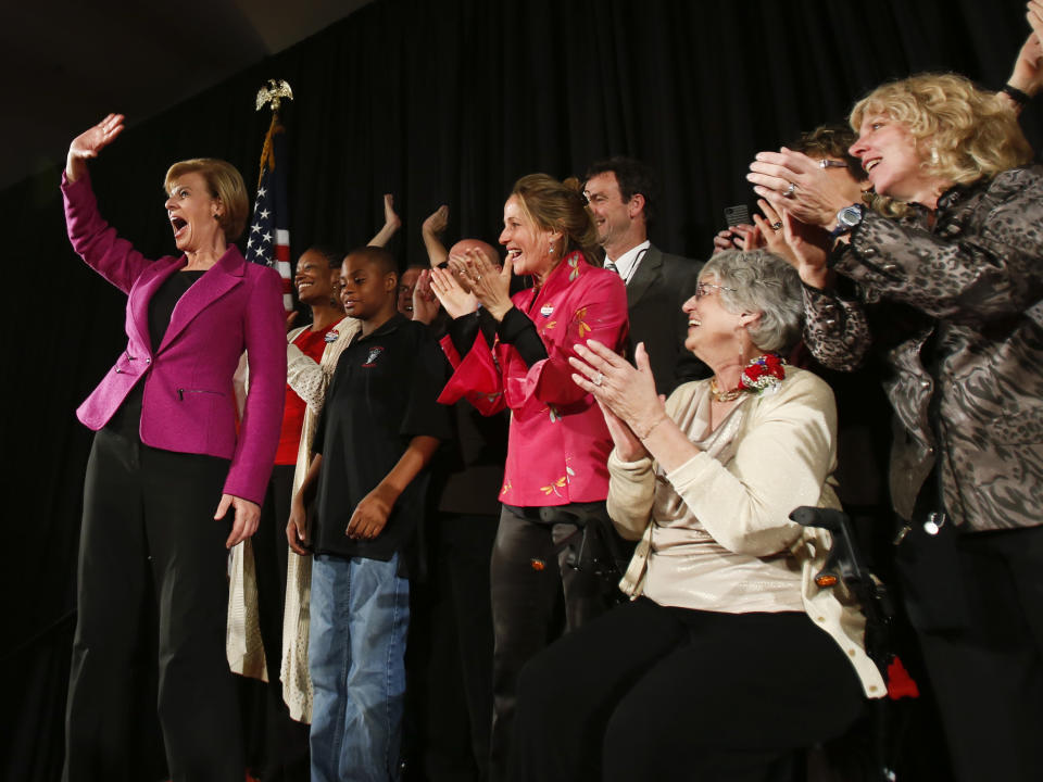 FILE - In this Tuesday, Nov. 6, 2012 file photo, U.S. Rep. Tammy Baldwin, D-Madison, waves to supporters on her way to make a victory speech in Madison, Wis. Baldwin will be one of a record 20 women, and the first openly gay senator, in the next Senate, 17 of them Democrats. (AP Photo/Andy Manis)