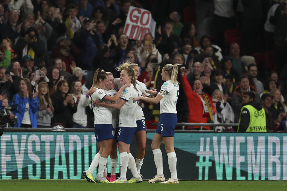 England's Ella Toone, left, celebrates with teammates after scoring the opening goal during the Women's Finalissima soccer match between England and Brazil at Wembley stadium in London, Thursday, April 6, 2023. (AP Photo/Ian Walton)