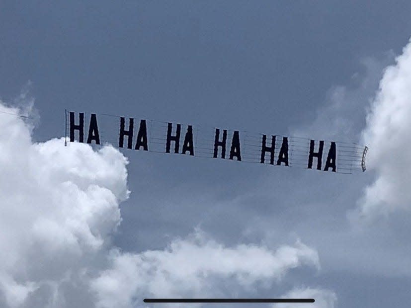 Trump critics flew a banner that read "HA HA HA HA HA HA" above protestors at his Mar-a-Lago residence after his house was raided by the FBI.