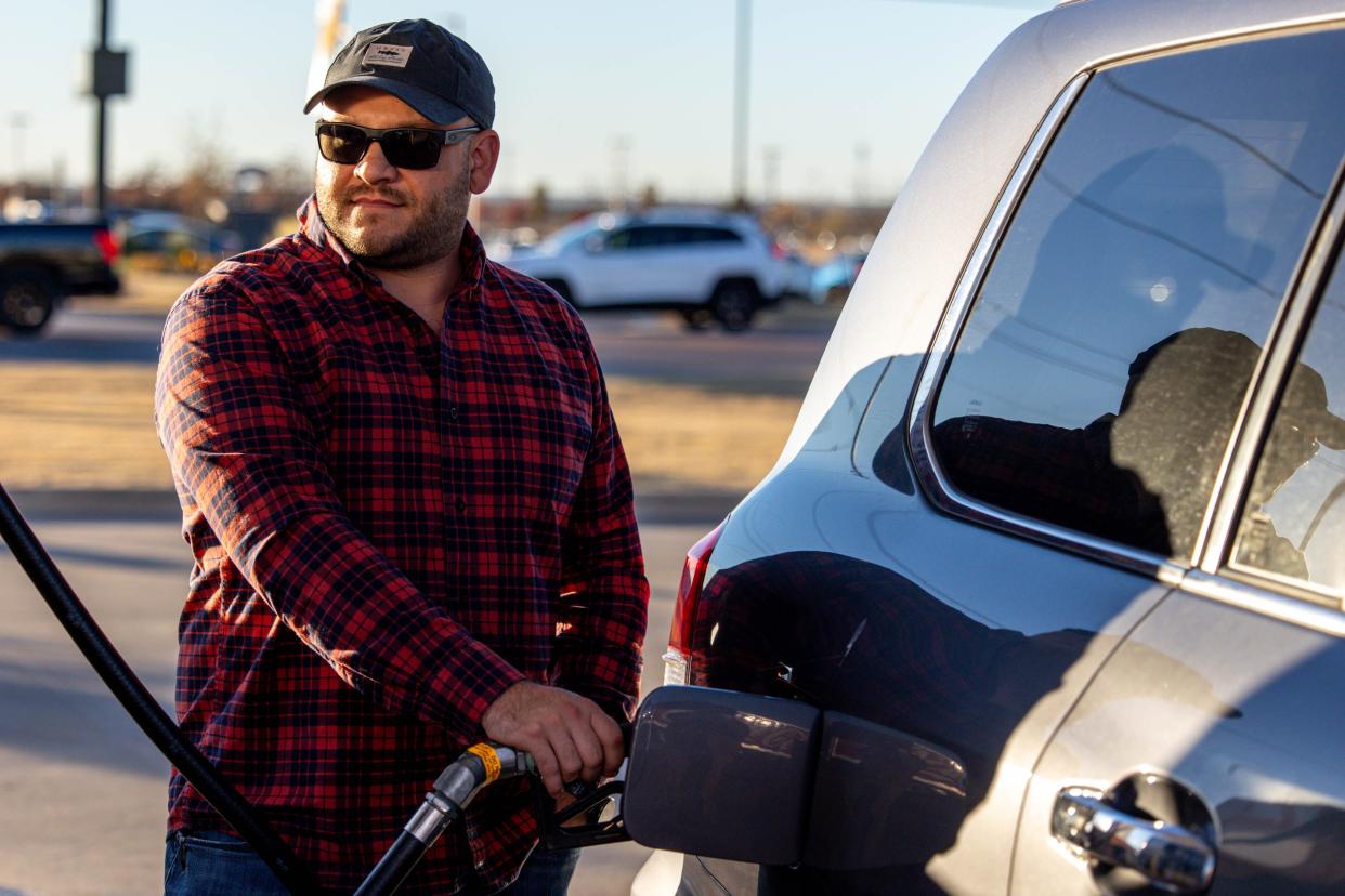 Brock Chance pumps gas in Oklahoma City. State transportation officials are wrapping up a study requested by lawmakers looking a potential switch from fuel taxes to mileage fees.