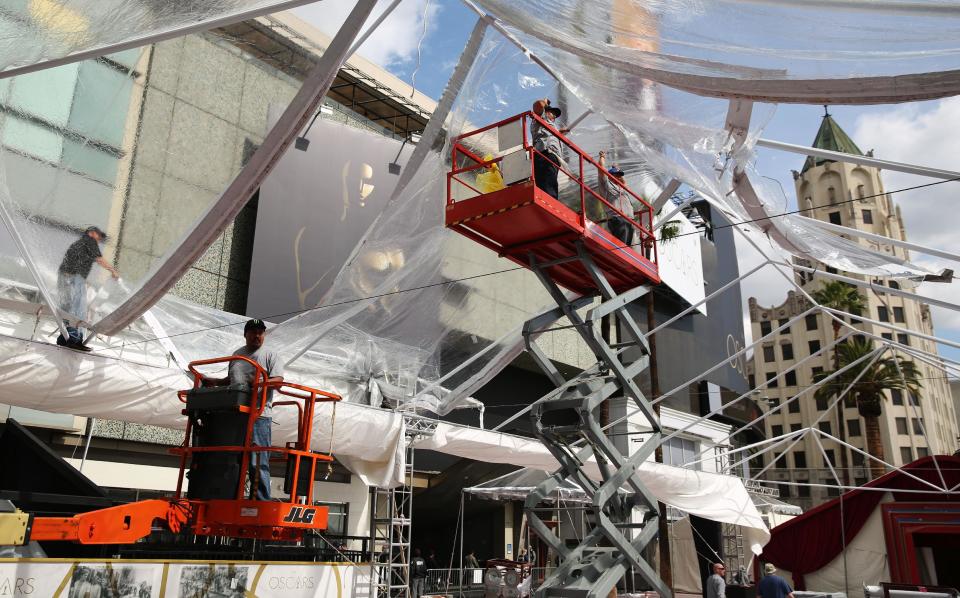 Workers construct a tent as preparations are made for the 86th Academy Awards in Los Angeles, Thursday, Feb. 27, 2014. The Academy Awards will be held at the Dolby Theatre on Sunday, March 2. (Photo by Matt Sayles/Invision/AP)