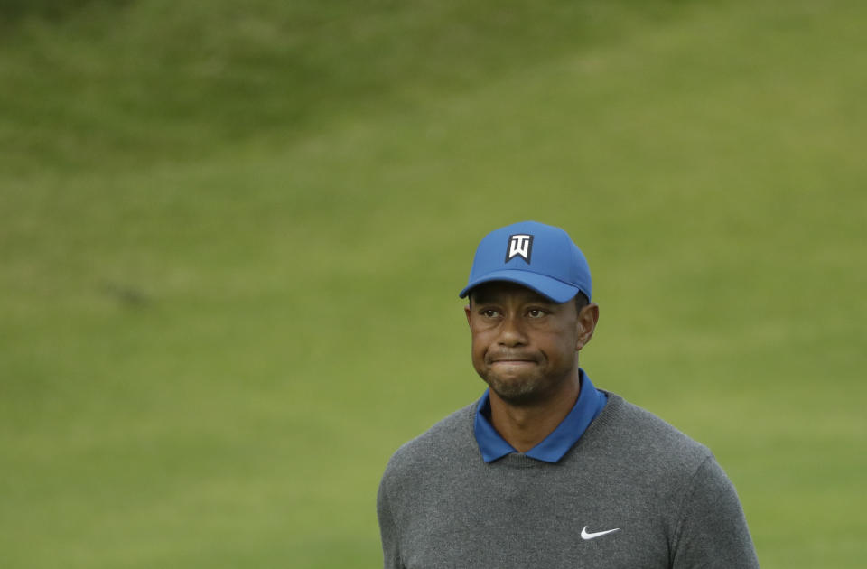 Tiger Woods of the United States looks up as he walks off the 18th green after completing his first round of the British Open Golf Championships at Royal Portrush in Northern Ireland, Thursday, July 18, 2019.(AP Photo/Matt Dunham)