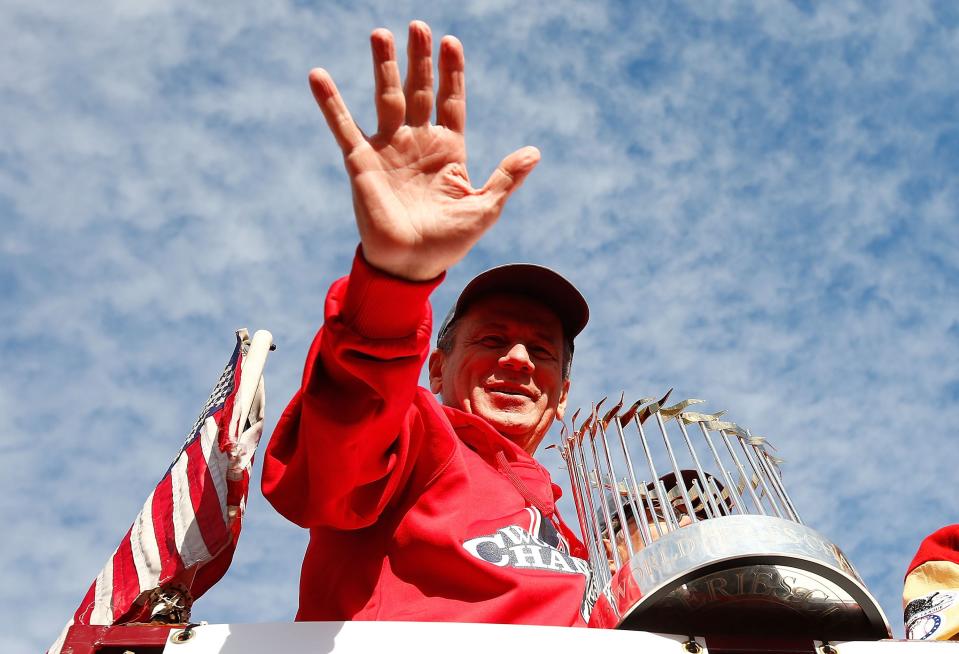 BOSTON, MA - NOVEMBER 02: President and Chief Exective Officer Larry Lucchino of the Boston Red Sox holds up the World Series trophy during the World Series victory parade on November 2, 2013 in Boston, Massachusetts.  (Photo by Jared Wickerham/Getty Images)