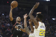 Toronto Raptors guard Norman Powell, left, shoots against Golden State Warriors guard Andrew Wiggins (22) and guard Damion Lee during the first half of an NBA basketball game in San Francisco, Thursday, March 5, 2020. (AP Photo/Jeff Chiu)