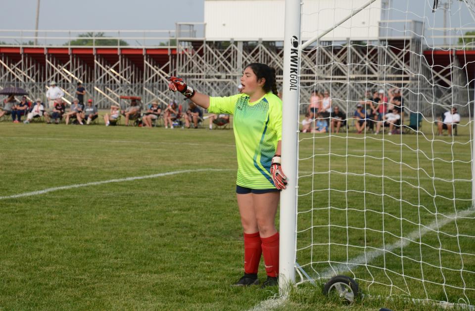 Milan goalie Olivia Henry positions her teammates as Grosse Ile lines up a free kick in the finals of the Division 3 District at Milan Friday night.  Grosse Ile won 2-1 on a penalty-kick shootout.