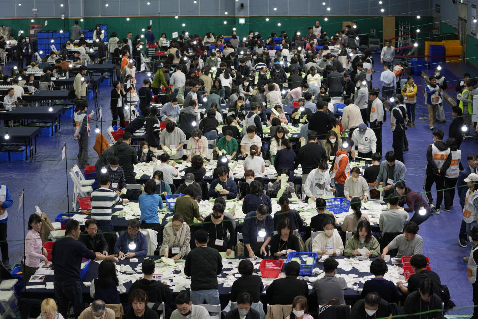 National Election Commission officials sort out ballots for counting at the parliamentary election in Seoul, South Korea, Wednesday, April 10, 2024. (AP Photo/Lee Jin-man)