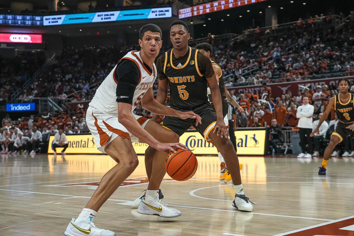 Texas Longhorns forward Kadin Shedrick (5) is guarded by Wyoming Cowboys forward Cam Manyawu (5) during the game at the Moody Center on Sunday, Nov. 26, 2023 in Austin.